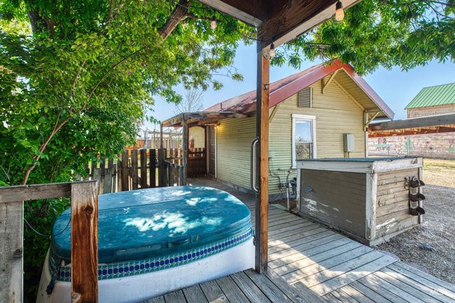 Wooden deck featuring a covered hot tub | Image 38
