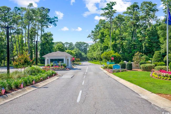 View of asphalt road featuring curbs, traffic signs, and street lighting | Image 35