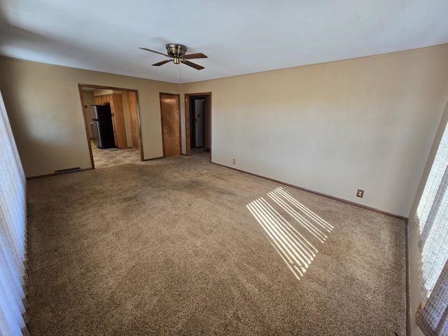 Living room has ceiling fan & closet | Image 11