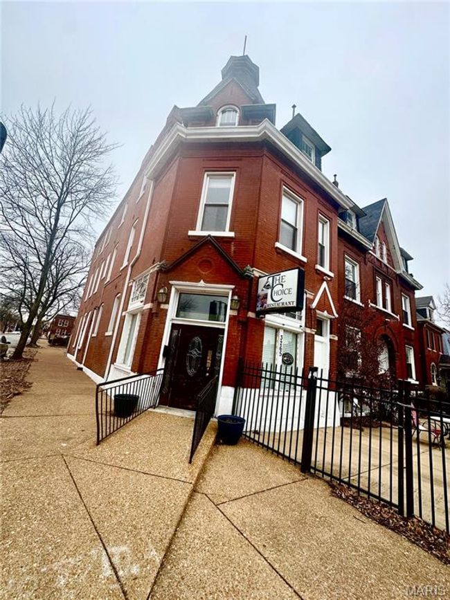 View of front of house featuring fence and brick siding | Image 4