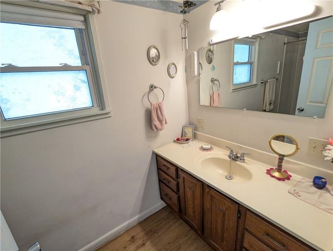 Bathroom featuring baseboards, wood finished floors, and vanity | Image 29