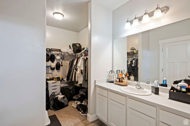 Bathroom featuring vanity and a walk in closet | Image 10