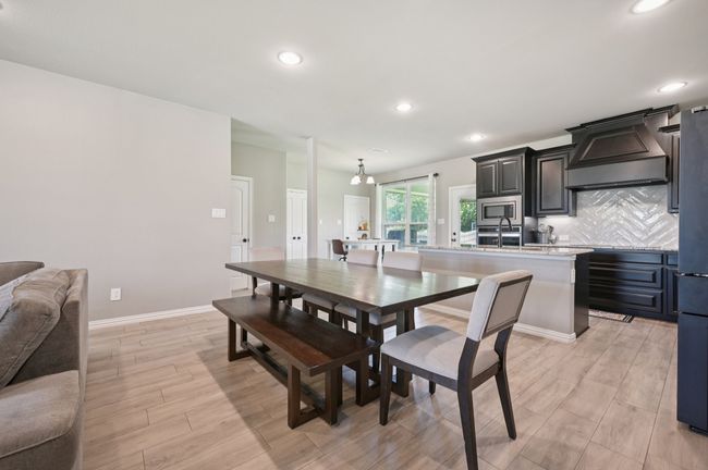 Dining room with recessed lighting and light wood-style flooring | Image 5