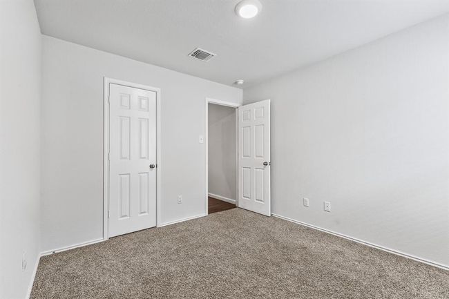 Unfurnished bedroom with carpet flooring and baseboards | Image 12