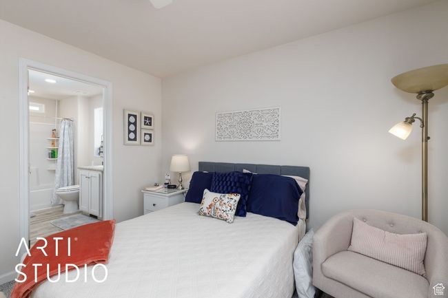Bedroom with ensuite bath and wood finished floors | Image 19