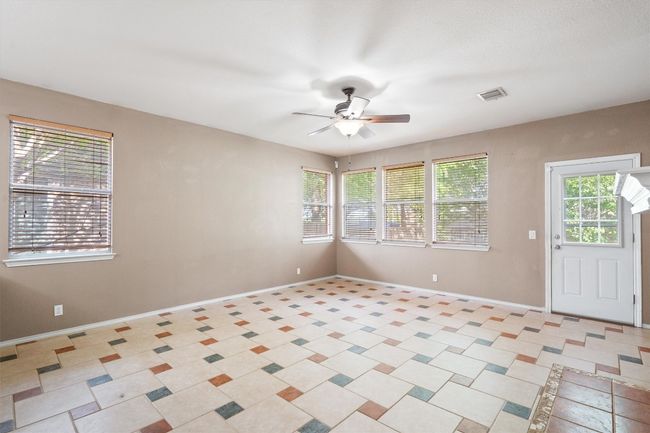 Living room with tile and ceiling fan | Image 10