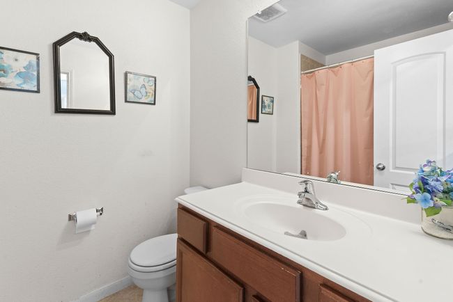 Bathroom with baseboards, visible vents, toilet, and vanity | Image 23