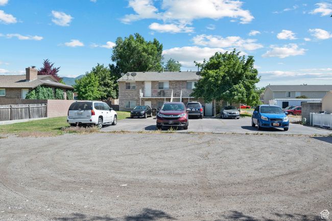 Uncovered parking lot featuring a residential view | Image 6