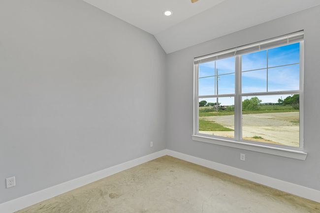 Spare room with concrete floors, baseboards, lofted ceiling, recessed lighting, and ceiling fan | Image 21