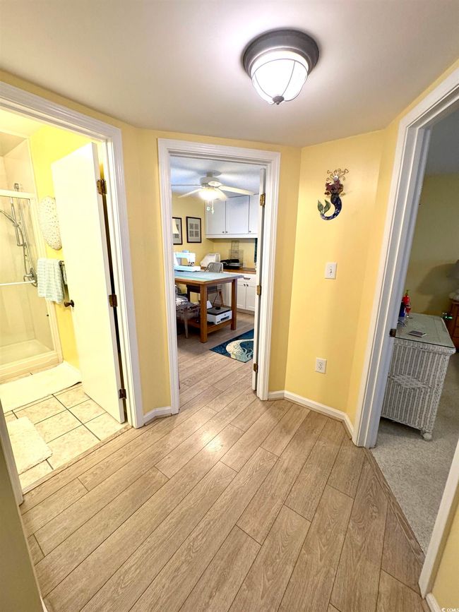 Hallway featuring light wood-type flooring and a desk | Image 24