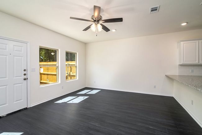 Empty room with dark hardwood / wood-style flooring and ceiling fan | Image 5