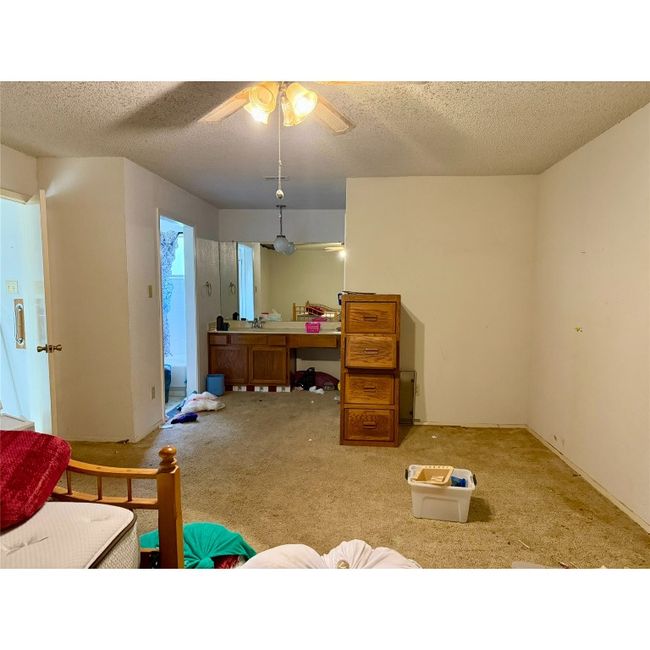 Bedroom with carpet, a textured ceiling, and a ceiling fan | Image 29