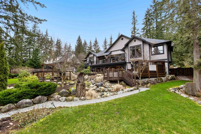 Rear view of property featuring stairs, fence, a deck, and a yard | Image 36
