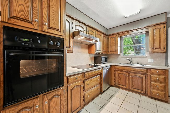 Unfurnished bedroom with wood finished floors and a ceiling fan | Image 15