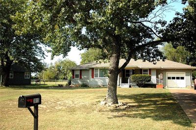 Single story home with a garage and a front lawn | Image 2