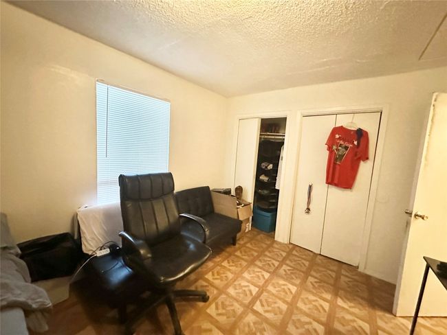 Sitting room featuring a textured ceiling | Image 13
