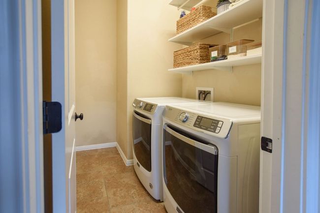 Clothes washing area with baseboards, laundry area, and separate washer and dryer | Image 23