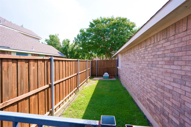 View of fenced backyard | Image 23