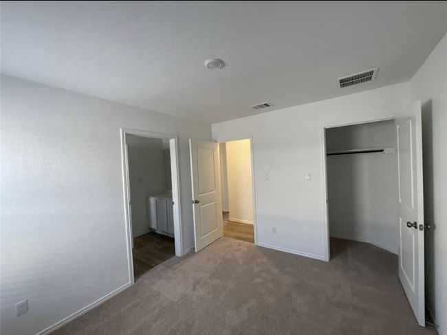Unfurnished bedroom featuring carpet, a closet, baseboards, and connected bathroom | Image 17