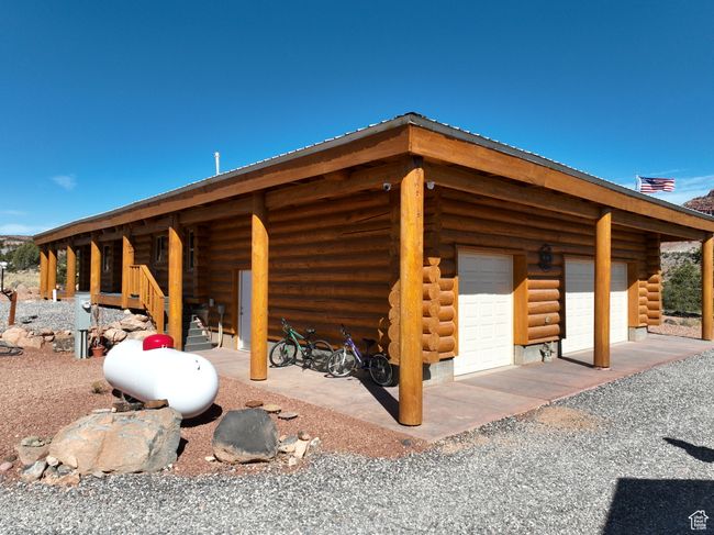 View of home's exterior featuring log siding, an outbuilding, and a garage | Image 28