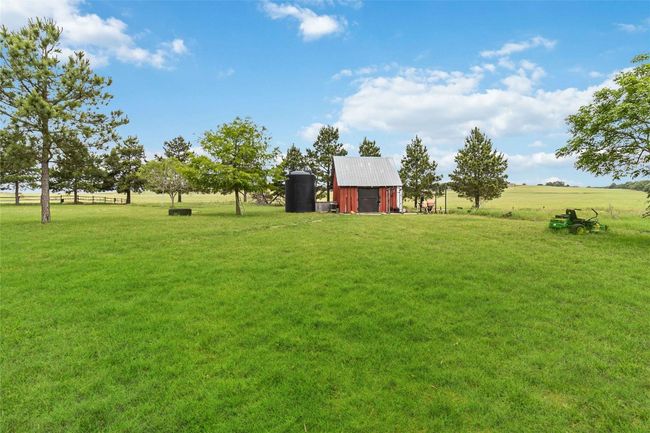 View of yard featuring an outdoor structure and a barn | Image 30