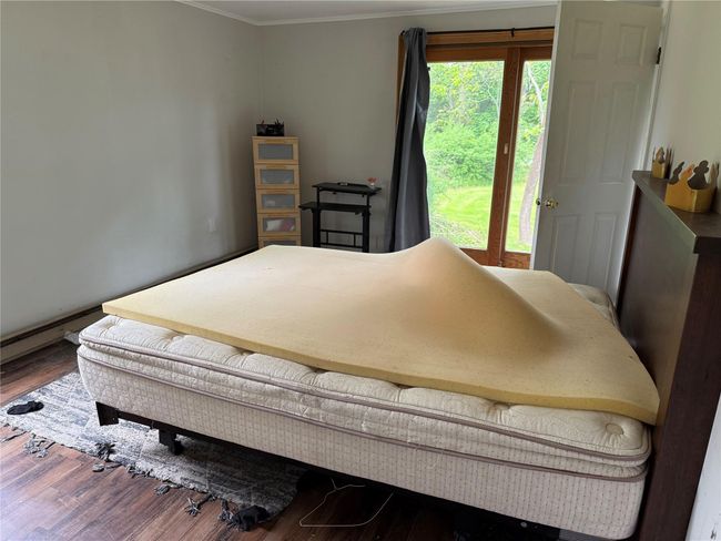 Bedroom with crown molding and wood finished floors | Image 8
