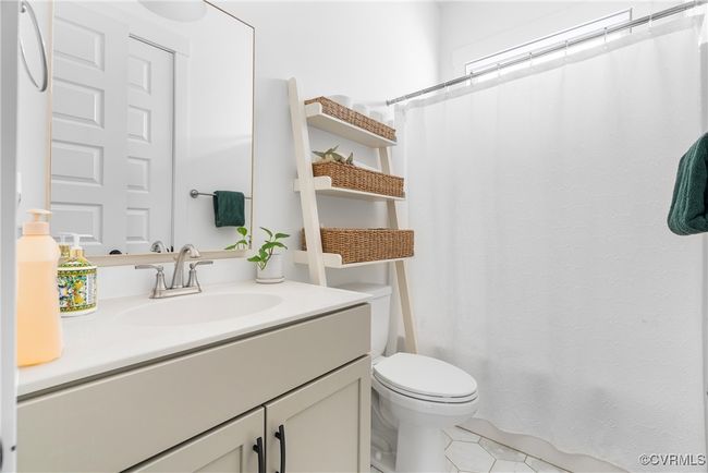 Bathroom featuring vanity, toilet, tile patterned floors, and a shower with shower curtain | Image 17