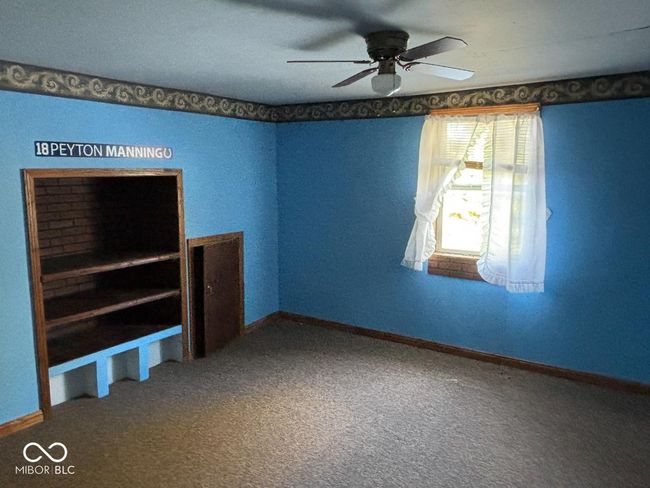 interior space featuring baseboards, a ceiling fan, and carpet | Image 6