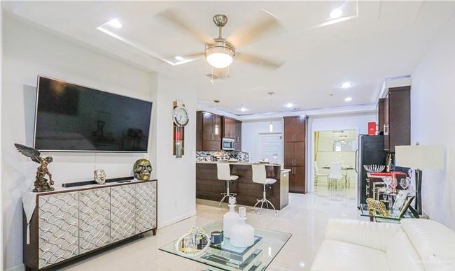 Tiled living room with a raised ceiling and ceiling fan | Image 4