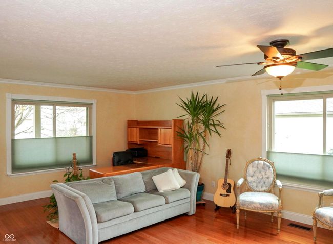 living room with wood finished floors, visible vents, and plenty of natural light | Image 4