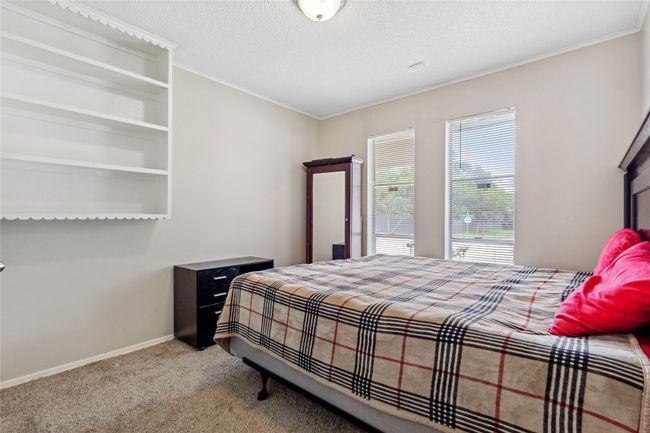 Carpeted bedroom featuring baseboards, ornamental molding, and a textured ceiling | Image 20