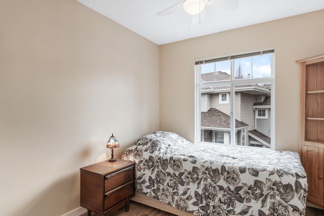 Bedroom with ceiling fan, wood finished floors, and baseboards | Image 24