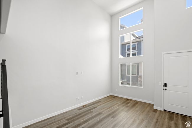 Entrance foyer with light wood-style flooring and a towering ceiling | Image 36