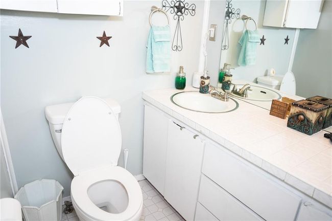 Bathroom featuring toilet and vanity | Image 14
