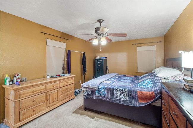 Bedroom with light carpet and ceiling fan | Image 16