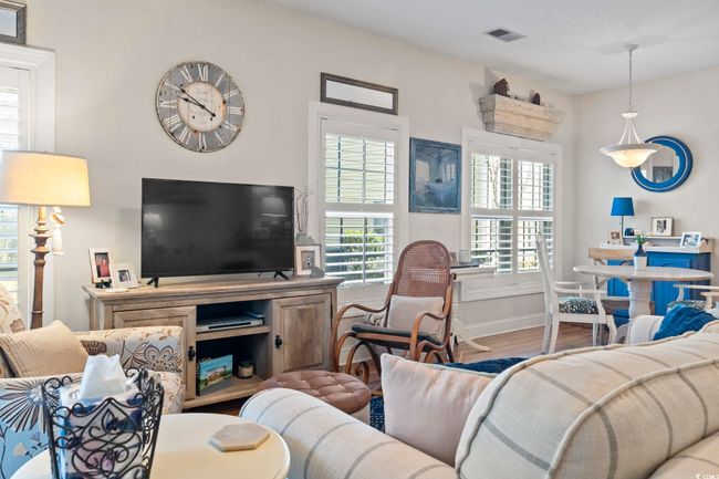 Living area with baseboards, visible vents, and wood finished floors | Image 17