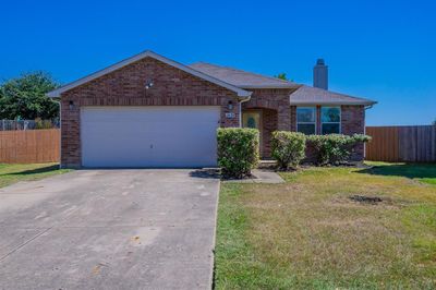 Single story home featuring a garage and a front lawn | Image 1