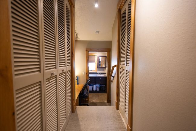 Hallway featuring a textured wall, a textured ceiling, and carpet floors | Image 23