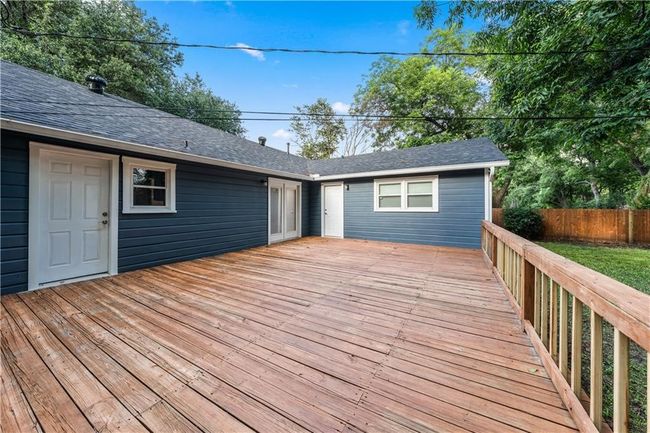 This deck will be removed and rebuilt as either a concrete patio or raised redwood deck stained to match the fence. | Image 38