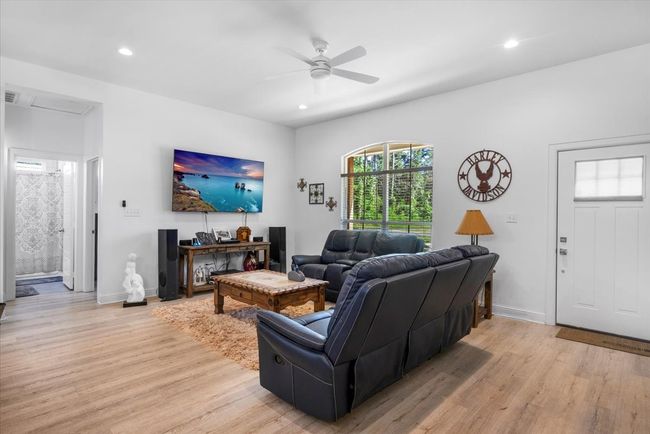 Living area featuring ceiling fan, light wood-type flooring, recessed lighting, and baseboards | Image 9