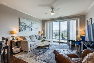 Living room featuring ceiling fan, dark hardwood / wood-style floors, and crown molding | Image 1