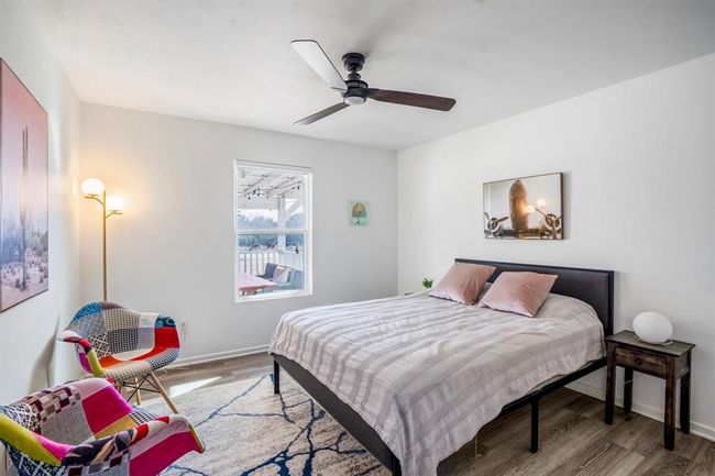 One of two additional bedrooms in the main home—each offering comfortable space and natural light. | Image 21