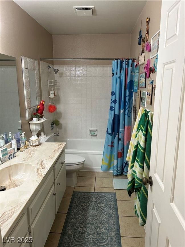 Bathroom featuring vanity, tile patterned flooring, and shower / bath combo | Image 25