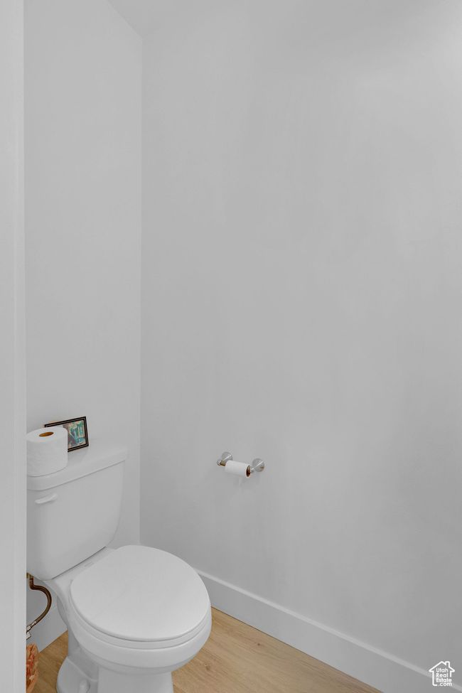 Bathroom with baseboards, toilet, and wood finished floors | Image 11