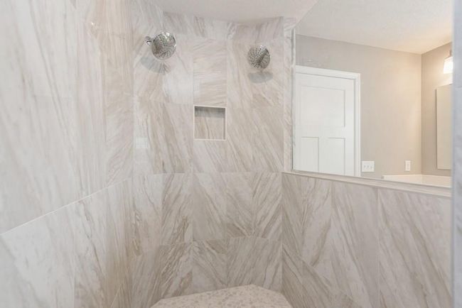 (Photo is of an inventory home, actual homes finishes will vary) Primary suite walk-in tiled shower with dual shower heads! | Image 15