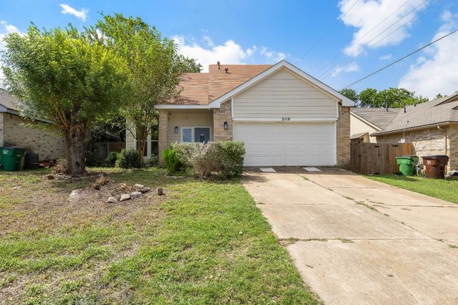 View of front of house featuring brick siding, driveway, and an attached garage | Image 31