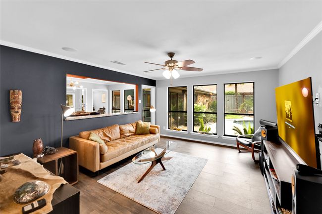Living room with ornamental molding and ceiling fan | Image 6