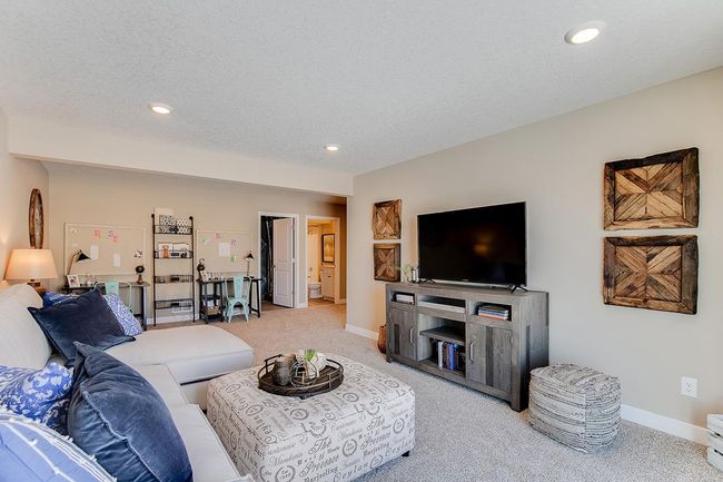 The lower level family room - comes FINISHED! Model home photo, colors and selections may vary. | Image 16
