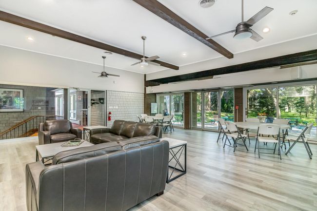 The party room opens to a lovely outdoor space and patio with grills. | Image 19