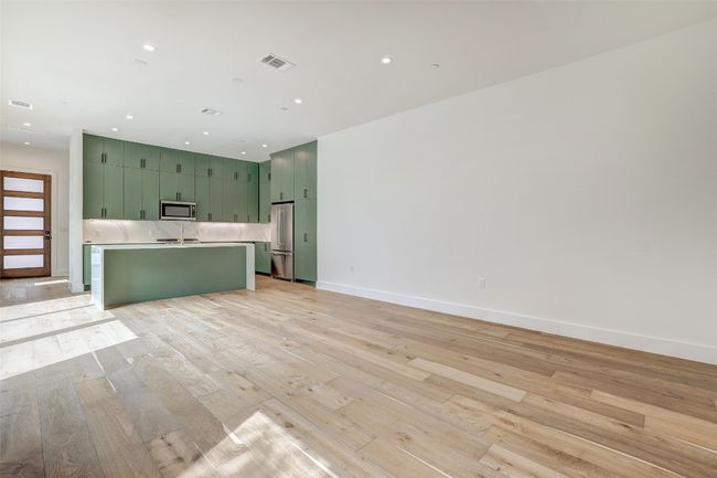 Unfurnished living room featuring light wood finished floors and recessed lighting | Image 13